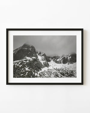 Snow-streaked Norwegian mountains beneath low cloud