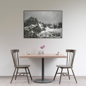 Rugged Norwegian cliffs above a snow-filled mountain basin