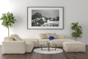 Moody Norwegian mountains with bright snow against dark stone
