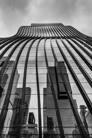 glass tower reflecting city buildings in Seoul