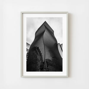 Monochrome photograph of a modern curved skyscraper in Seoul