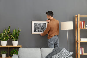 Metallic hand sculptures framed against curved glass tower