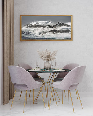 Panoramic Antarctic seascape with foaming waves and snow-covered ledges