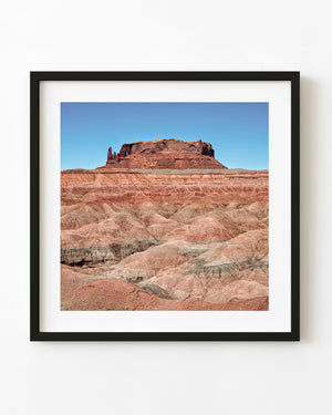 Southwest desert butte above layered badlands