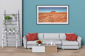 Warm eroded desert hills stretching across a wide Southwest landscape
