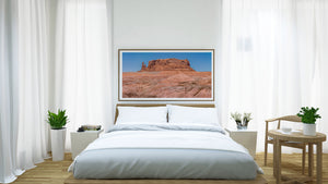 Wide desert vista of sculpted ridges and a distant red butte.