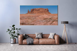 Pale desert hills contrasting with red sandstone under blue skies.
