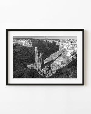 Spider Rock rises above the canyon floor in a black and white desert landscape.