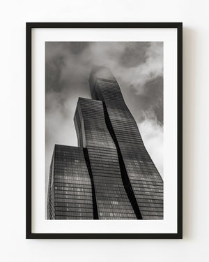 Upward black and white view of St Regis Tower Chicago with its upper floors in cloud.