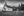 Small white wooden church with a bell tower and simple graveyard crosses.