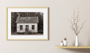 Old mission church cabin with boarded windows and peeling wooden siding.