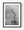 Statue of Liberty against soft grey clouds in black and white.