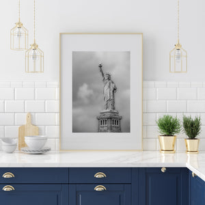 The Statue of Liberty holding her torch and tablet beneath soft clouds.