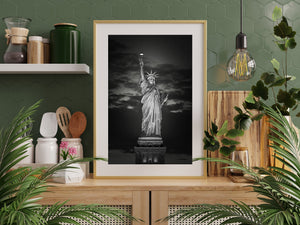 New York landmark illuminated above its pedestal at night.