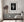 Bright torch and sculpted robes contrast with the deep tones of a night sky.