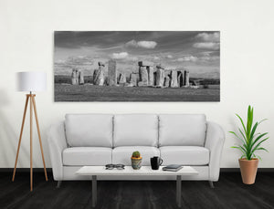 Black and white landscape of Stonehenge with sunlit weathered stones.