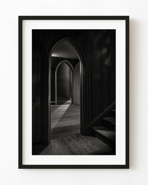 Gothic passageway at Strawberry Hill House with pointed arches and angled light in black and white.