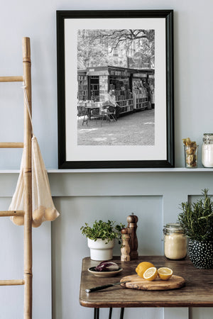 Fine art photo of man selling books in the city