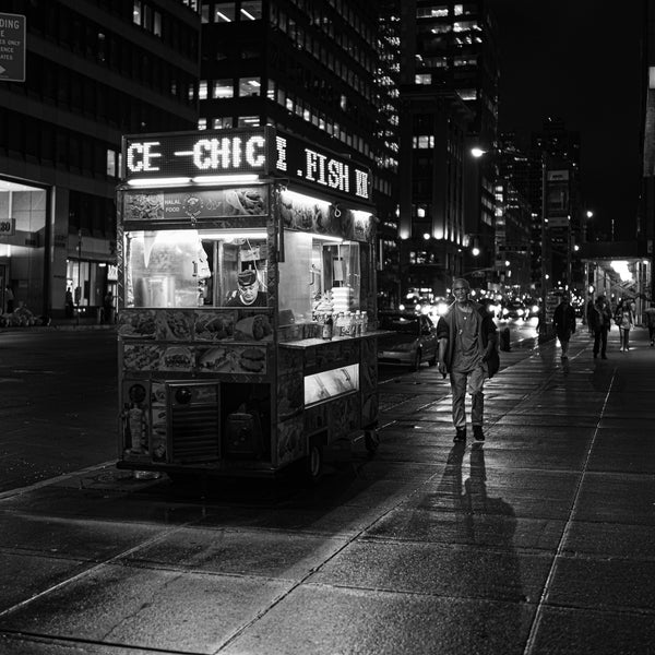 NYC night scene with local street food vendor