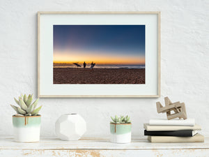 Sydney surf scene with boards, silhouettes and an orange sunrise horizon.