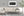 White chalk graffiti fills black panels in this panoramic Sydney street photograph.