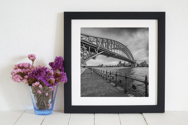 Couple walking on boardwalk near Sydney Harbor Bridge