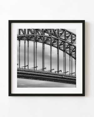 Close-up of Sydney Harbour Bridge steelwork and vertical supports in black and white.