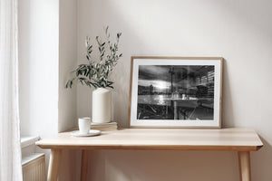Sunlight across Sydney Harbour merges with glassware and horizontal window slats.