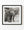 Tanzania elephant with spread ears, small tusks and a lowered trunk in black and white.