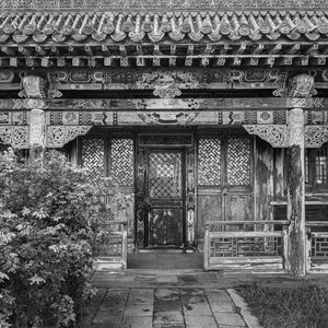 Weathered Mongolian temple entrance with carved wooden details