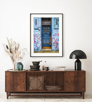 Weathered blue door with urban graffiti