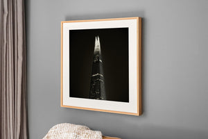 The Shard narrows into a luminous tip against an almost black sky.