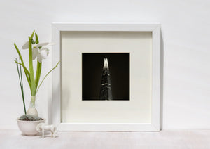 Toned monochrome study of The Shard with a bright crown and shadowed lower floors.