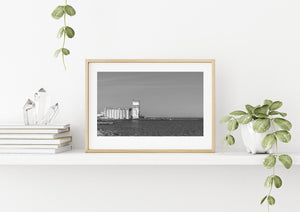 Quiet harbour scene with an abandoned grain elevator and open lake horizon.