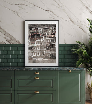 Tibetan homes form a dense pattern of pale trim, rough stone and sloping roofs.