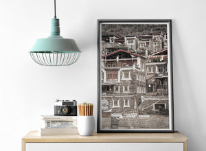 Vertical architectural view of closely built Tibetan houses and narrow steps.