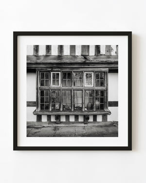 Timber-framed multi-pane window in Rye, England, photographed in black and white.