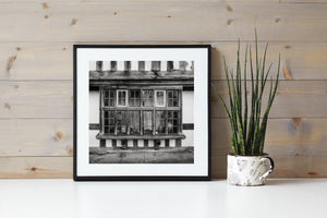Monochrome architectural detail of a projecting window on a half-timbered Rye building.