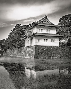 Imperial Palace guardhouse above a stone wall and its reflection in Tokyo