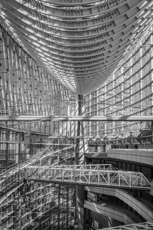 Sweeping ceiling ribs above glass walls inside Tokyo International Forum