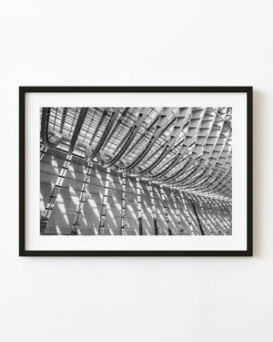 Steel roof ribs and diagonal shadows at Tokyo International Forum in black and white