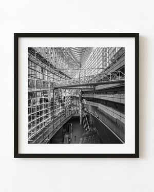 Suspended walkway inside Tokyo International Forum in black and white
