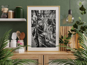 Monochrome photograph of a Tokyo vendor in a densely stocked stall