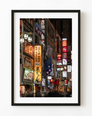 Colourful Shinjuku neon signs above a busy Tokyo street at night