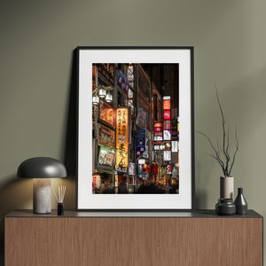 Shinjuku night scene with glowing storefront signs and moving crowds