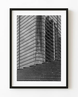 Tokyo shrine roof against a curved glass tower in black and white