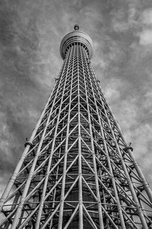 Upward view of Tokyo Skytree’s steel lattice beneath a cloudy sky
