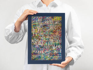 White graffiti tags over multicolored wall surface in Tokyo urban stairwell