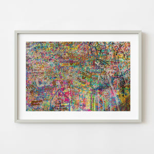 Colorful graffiti wall filled with layered tags in Tokyo stairwell