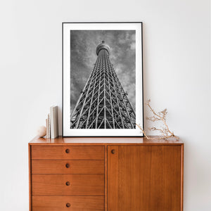 Looking upward at Tokyo Skytree lattice tower against dramatic clouds
